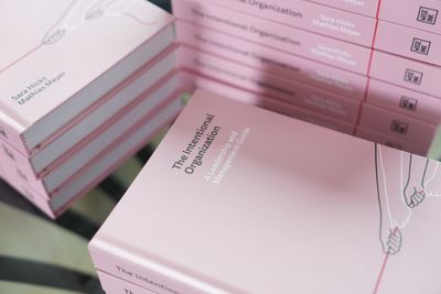 Stacked copies of the book, spines showing, with the cover illustration visible on the top copy