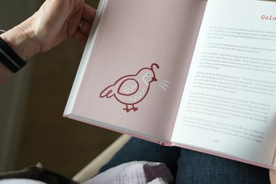 The book’s colophon page, with paragraphs of body text next to a quail illustration